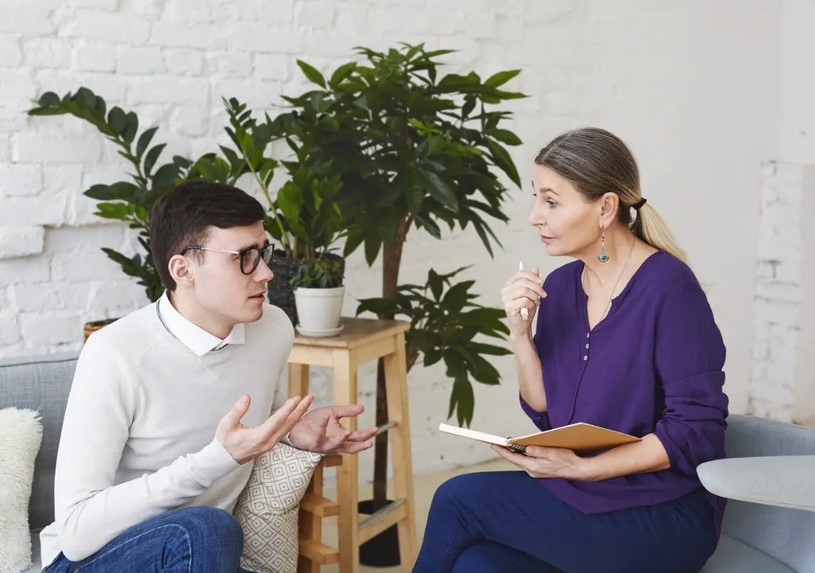 An individual speaking with their therapist.