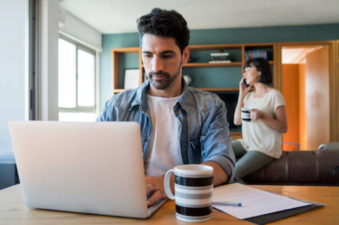 A man focused on his laptop.
