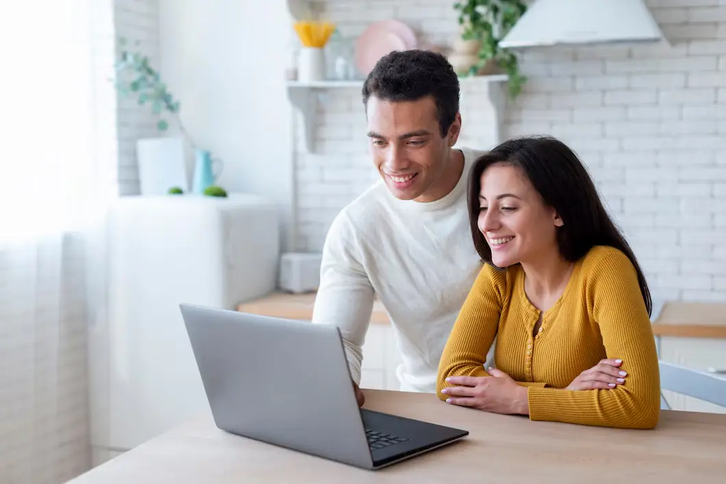 A couple setting up a telehealth therapy session.