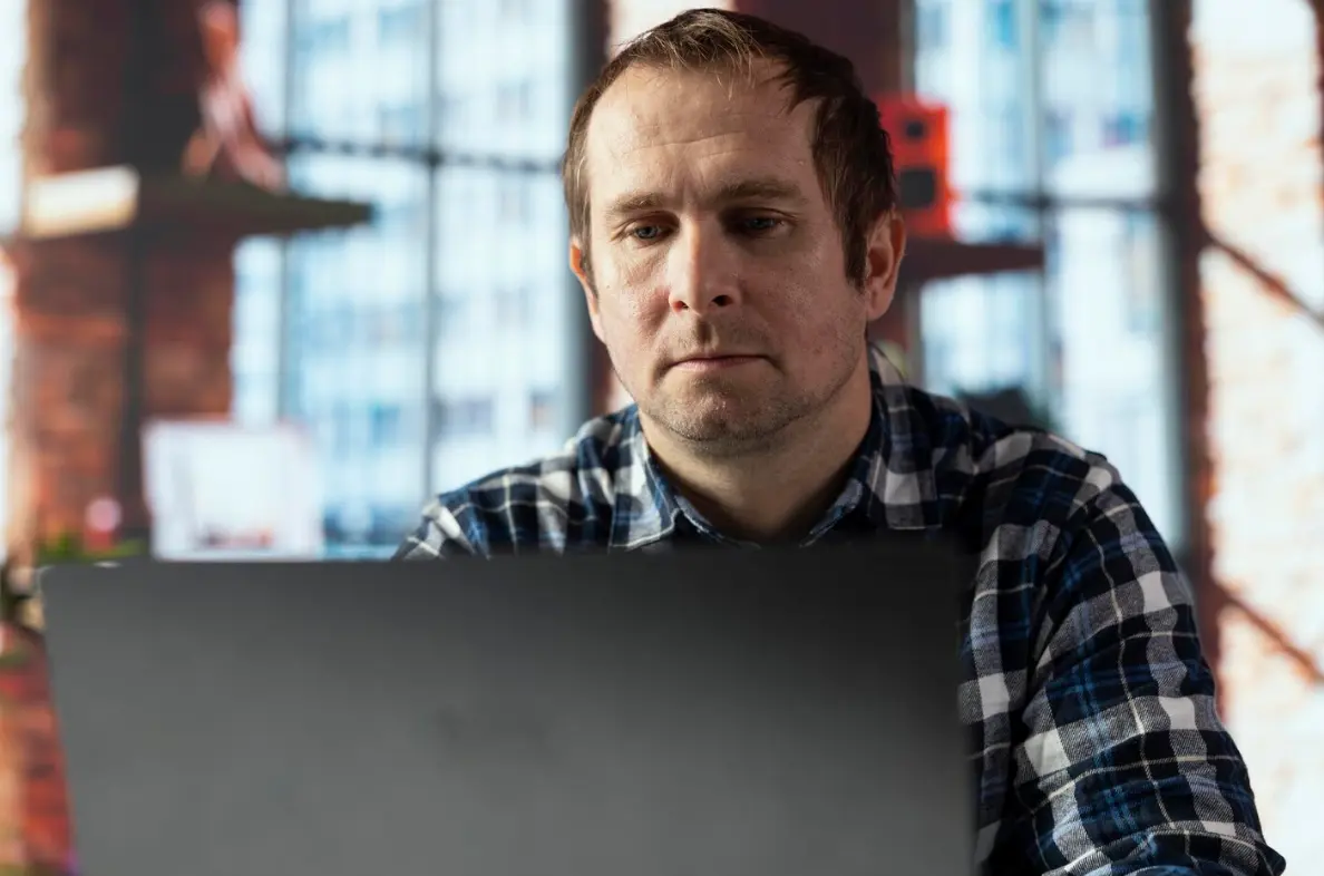 A man speaking with a telehealth therapist in CA.