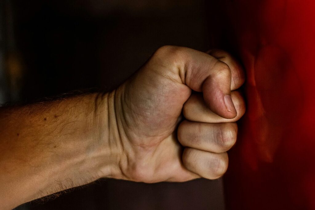A fist hits a red surface