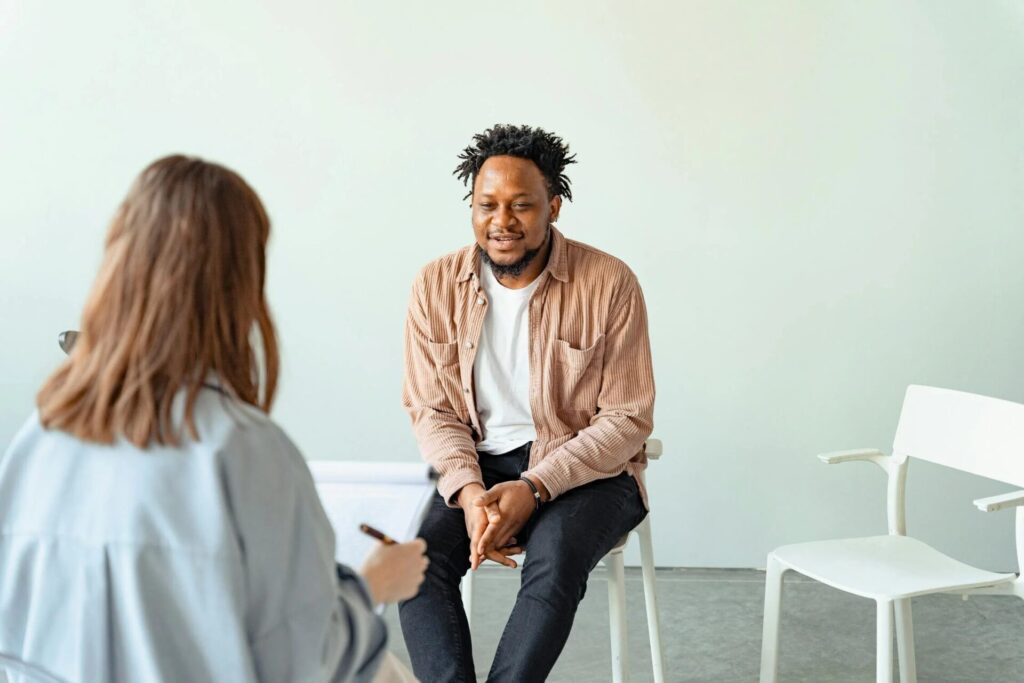 A licensed therapist offering guidance to a patient, fostering growth and resilience.
