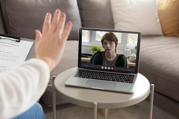 Woman participating in an online therapy session.