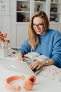 An image of a woman looking at her laptop