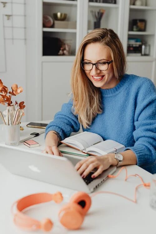An image of a woman looking at her laptop