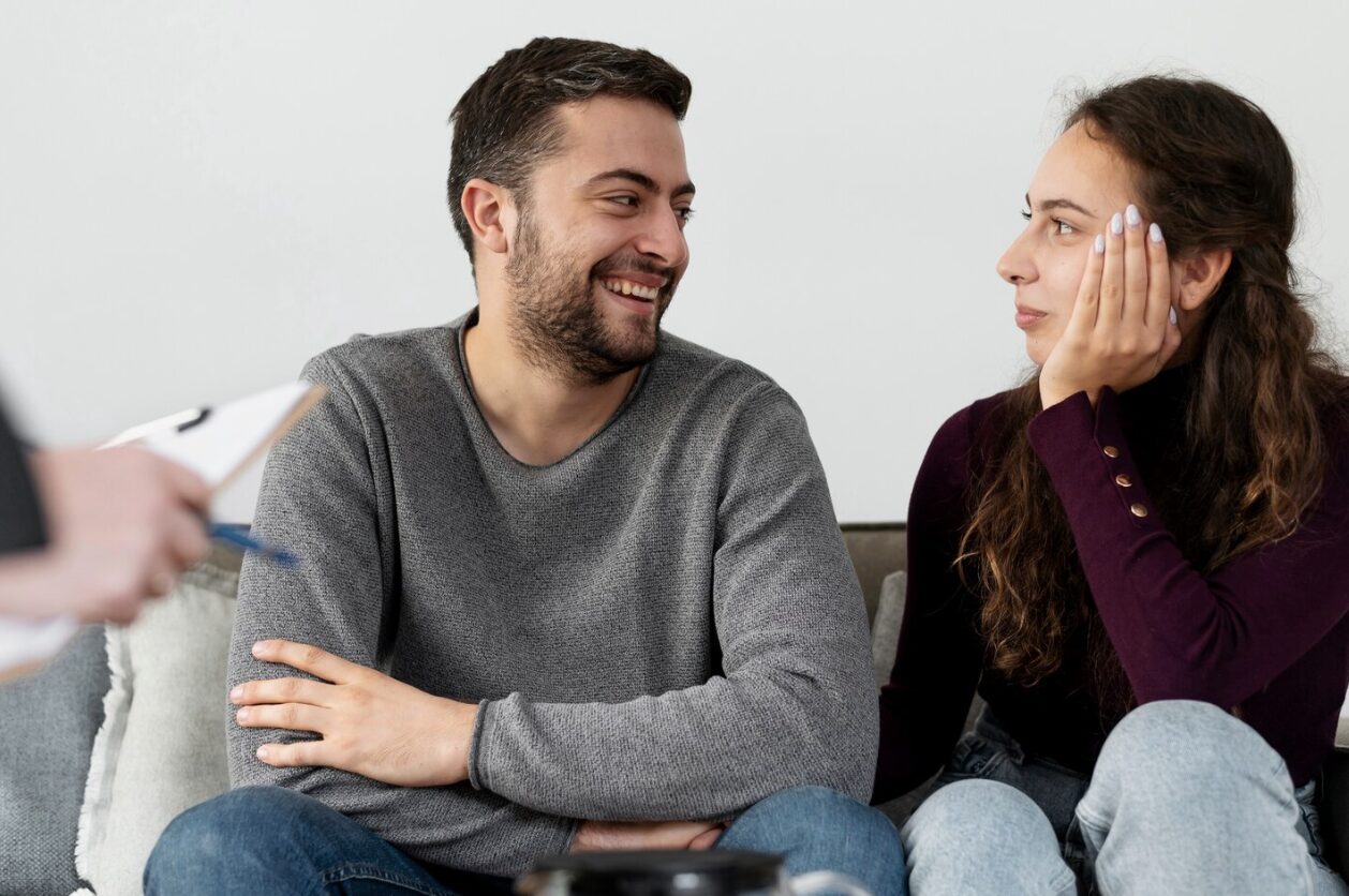 A couple sitting next to each other in a counseling setting in Corona.