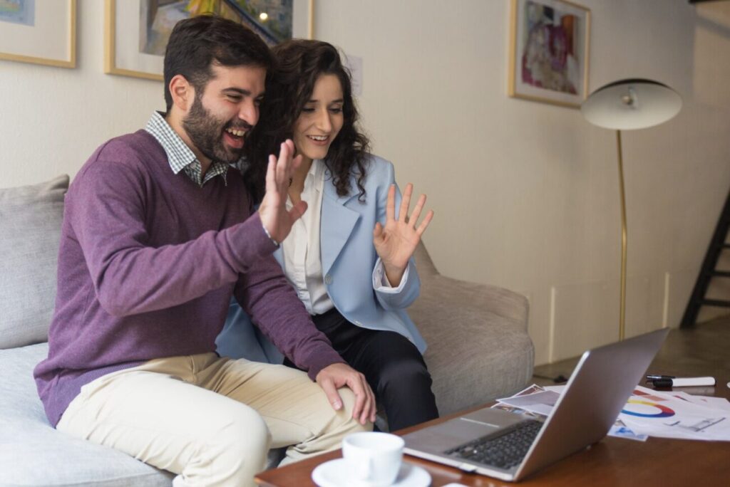 A happy couple waving hello to a therapist.