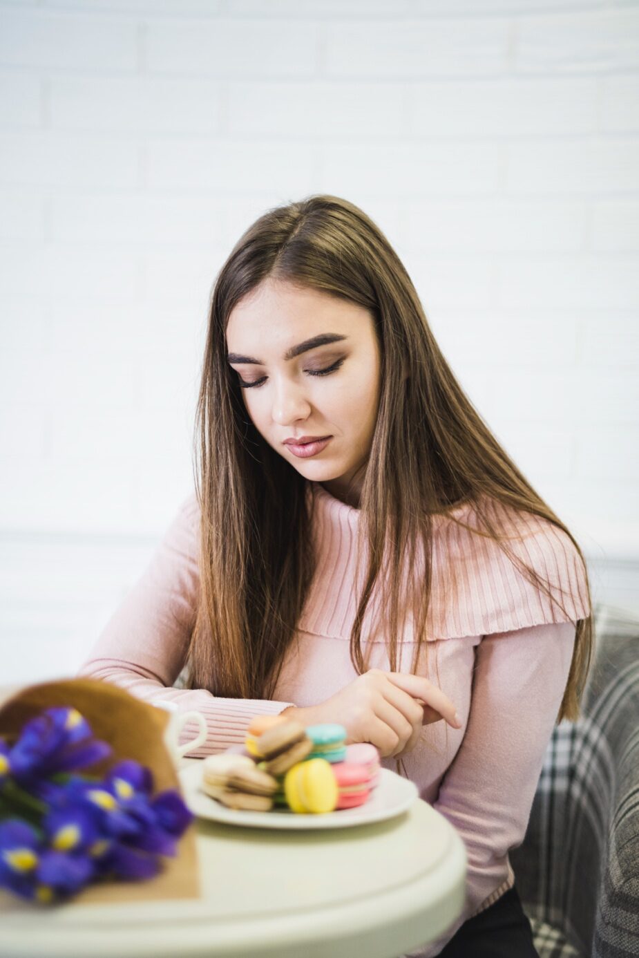 A young woman looking anxiously at food.
