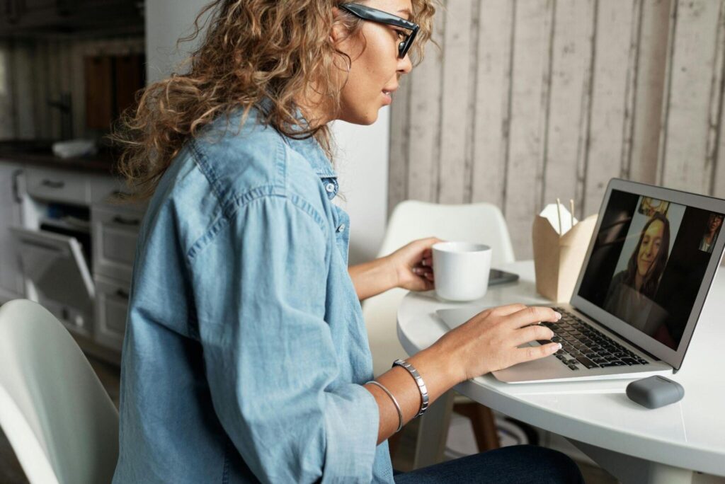 Woman sitting at home on a video call on her laptop.